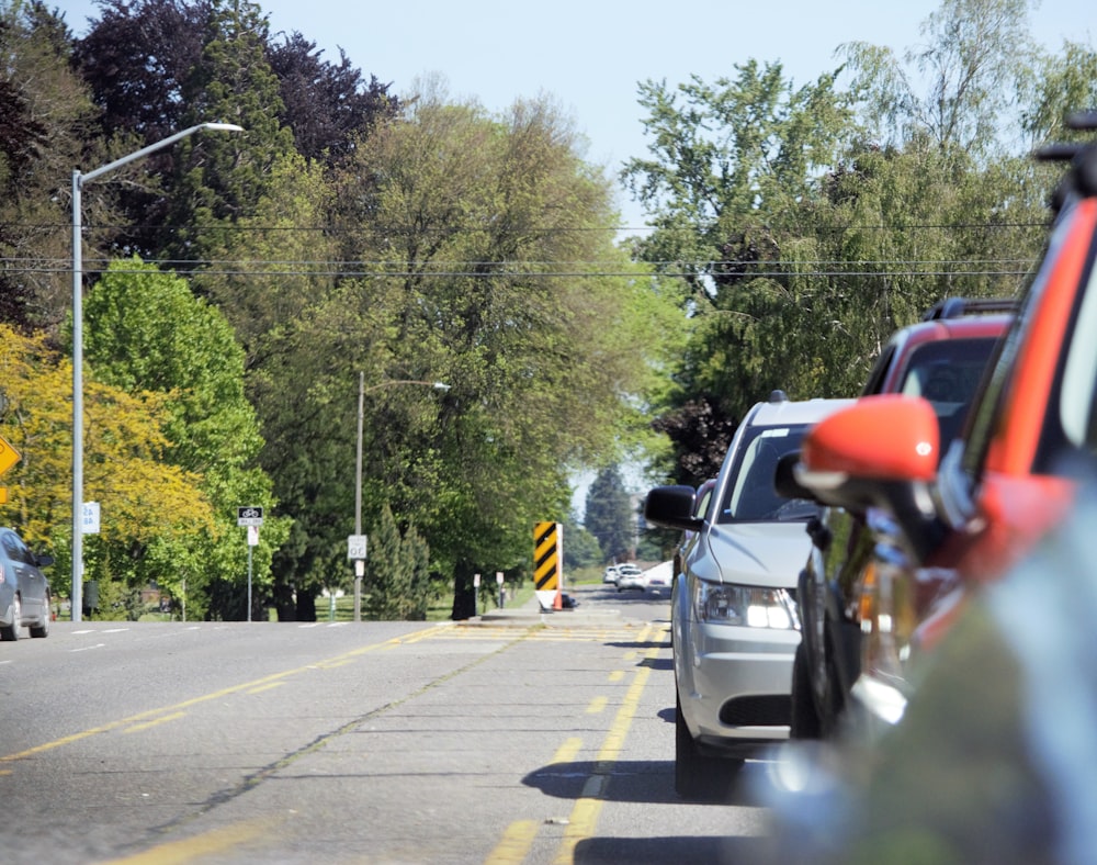 a line of cars parked on the side of a road