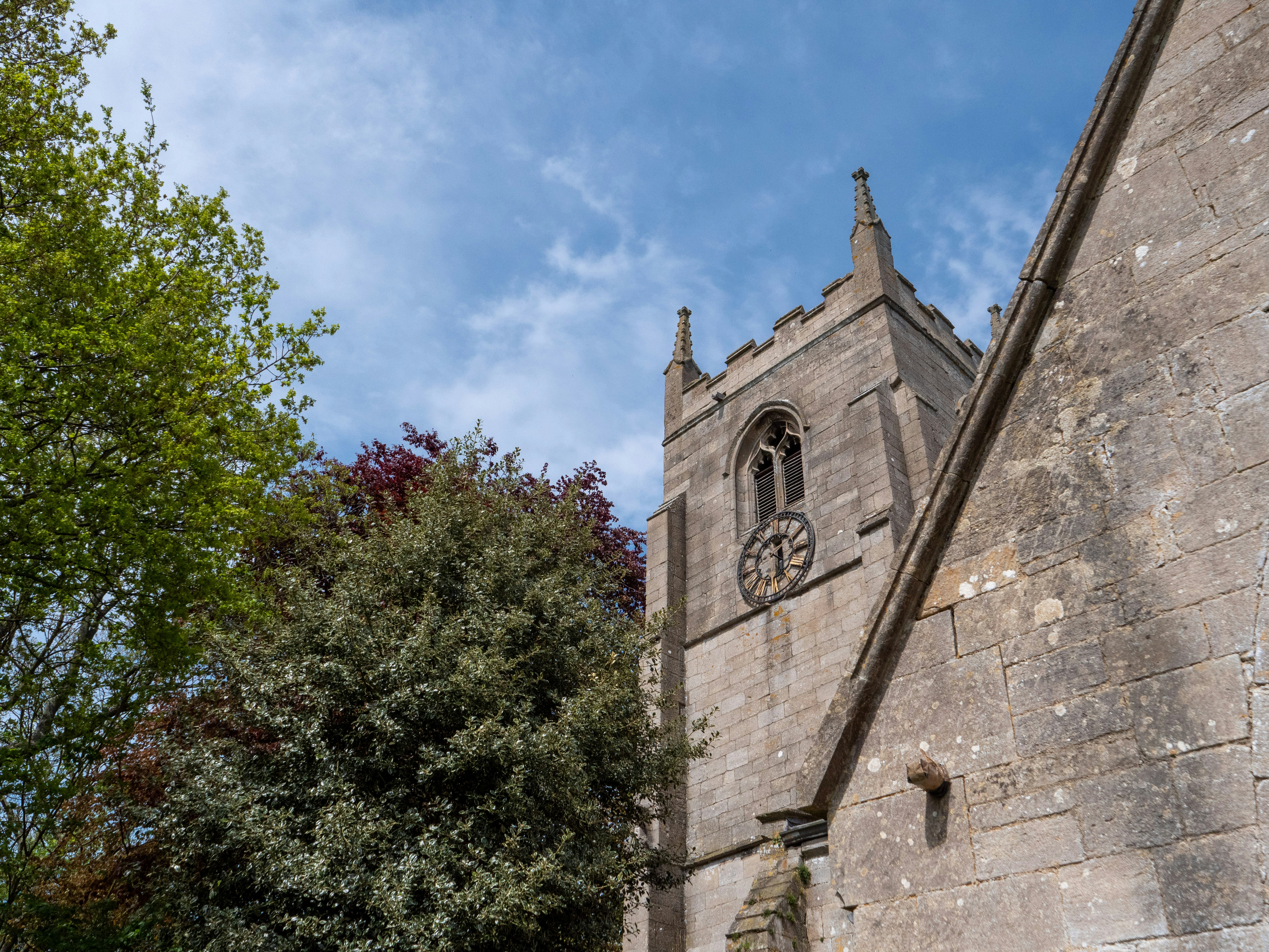 a stone building with a clock on the side of it