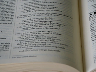 A warm, golden light illuminating an ancient Bible opened on a wooden table.