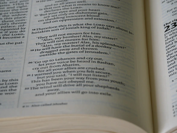 A warm, golden light illuminating an ancient Bible opened on a wooden table.