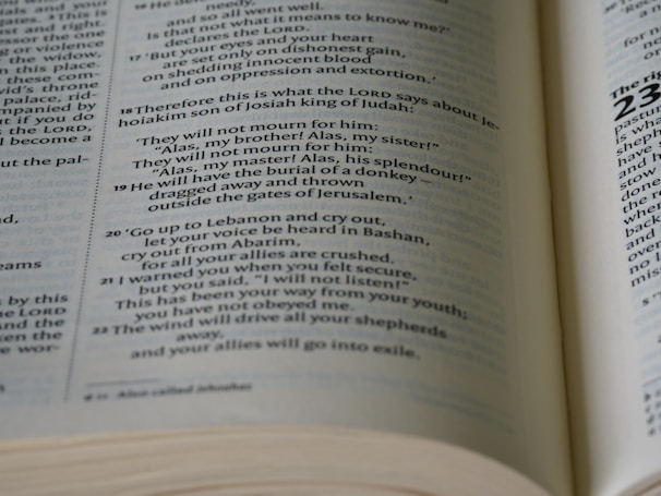 An open Bible with a warm light illuminating its pages.