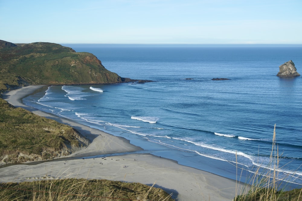 a view of a beach and a rock outcropping