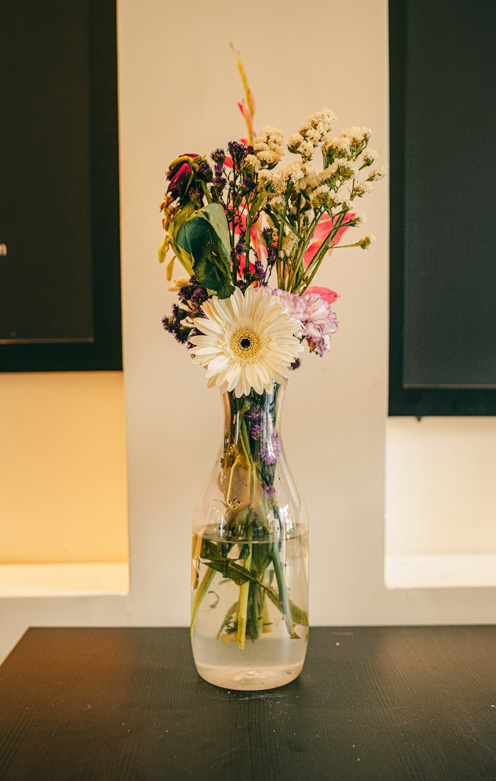 a vase filled with flowers sitting on top of a table