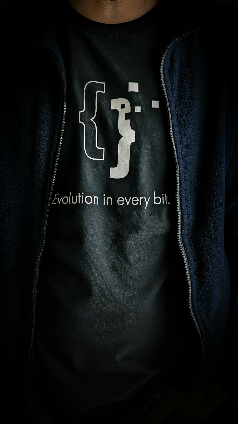a man wearing a t - shirt with the words evolution in every bit on it