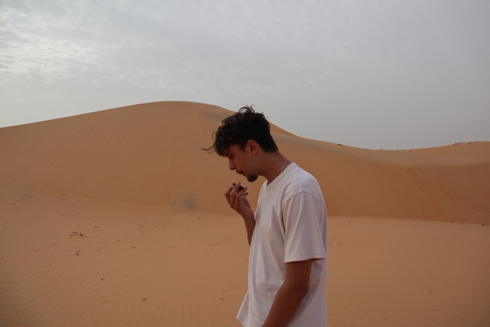 a man standing in the middle of a desert