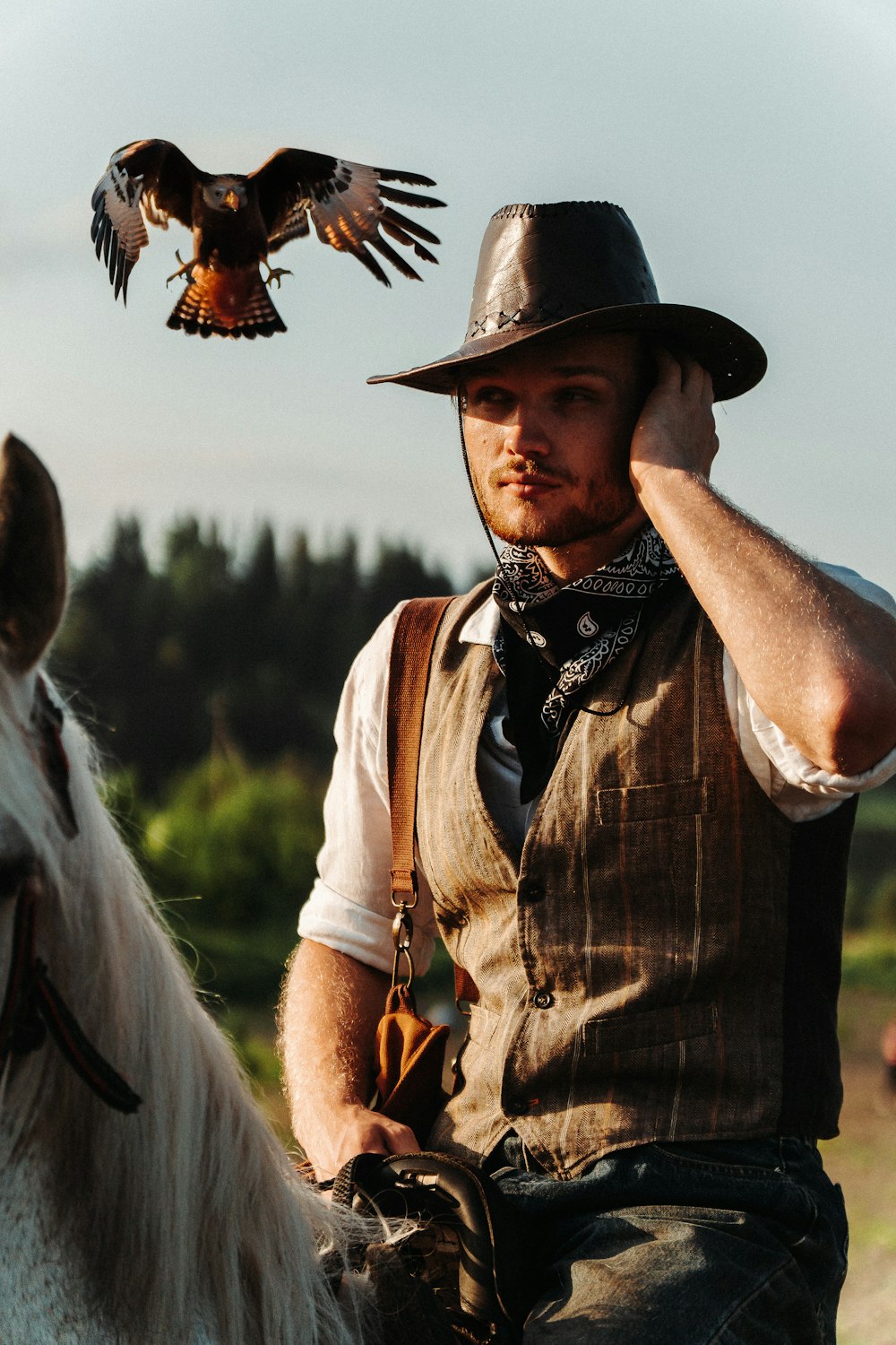 a man on a horse with a bird on his shoulder