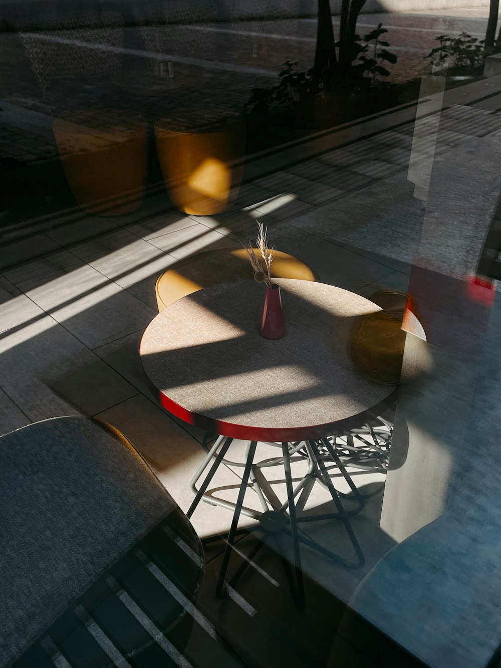 a table and chairs are seen through a window