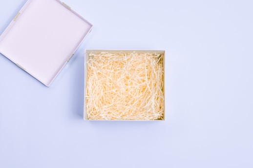 a box of shredded cheese on a blue background