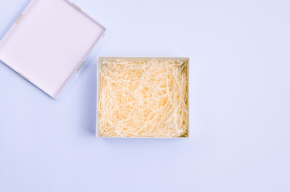 a box of shredded cheese on a blue background