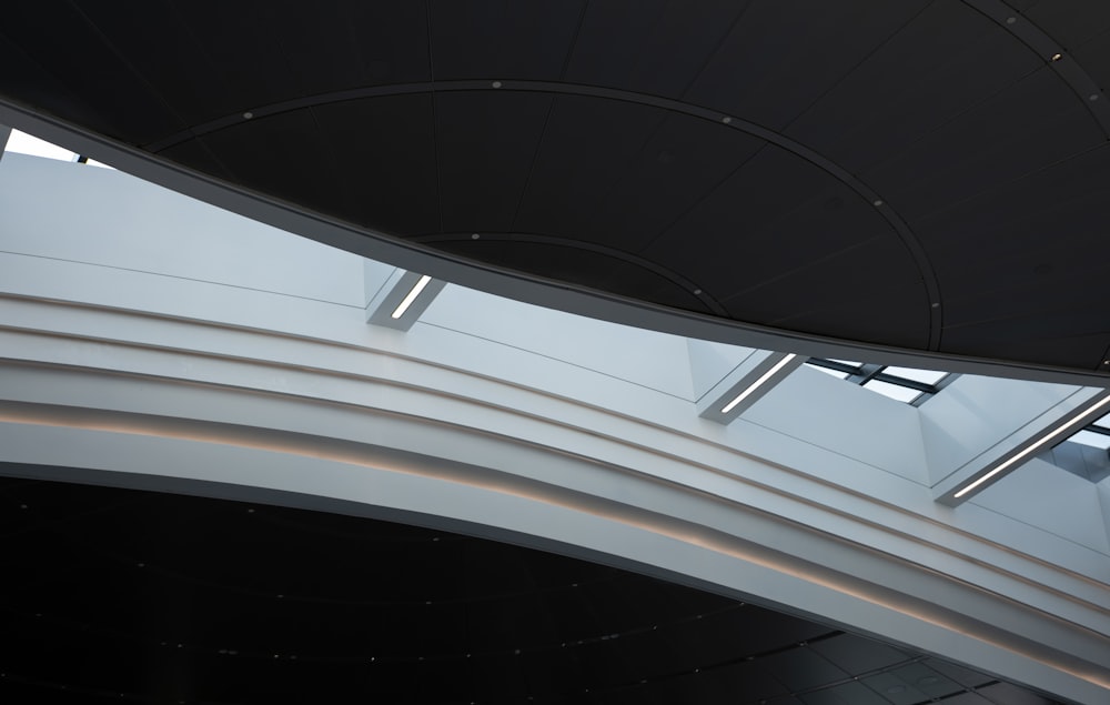 a curved ceiling in a building with a clock on it