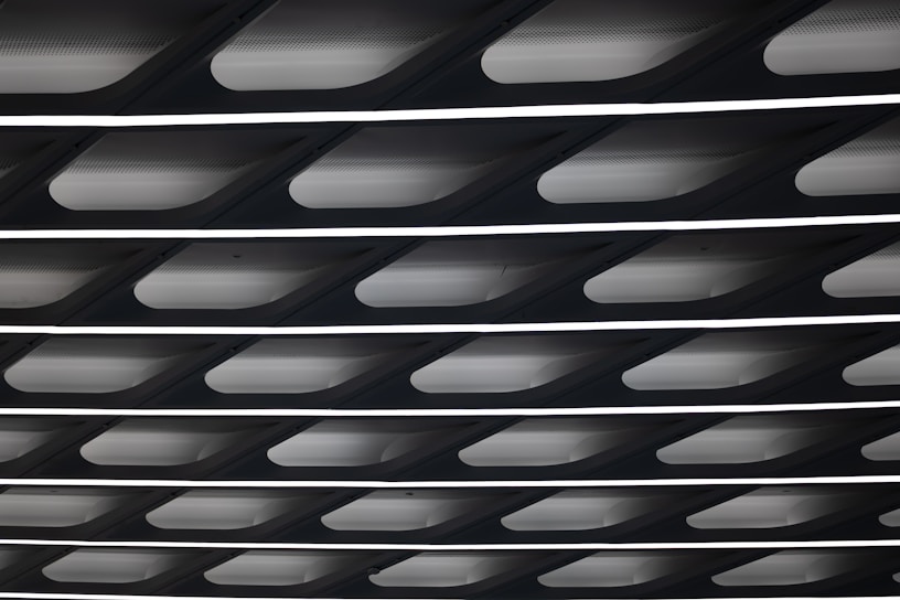 Close-up of a sleek bex LED strip illuminating a modern architectural ceiling.