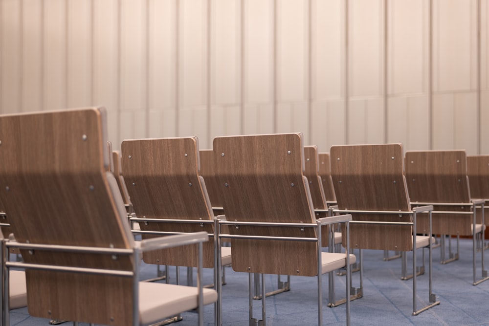 a row of wooden chairs sitting next to each other