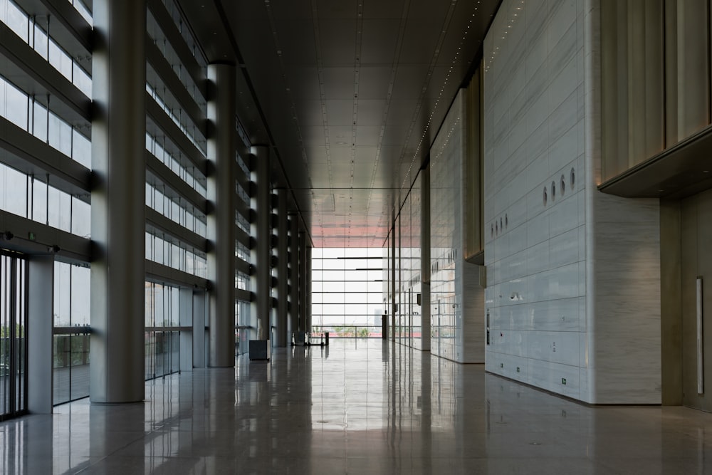 a large hallway with a lot of windows next to it