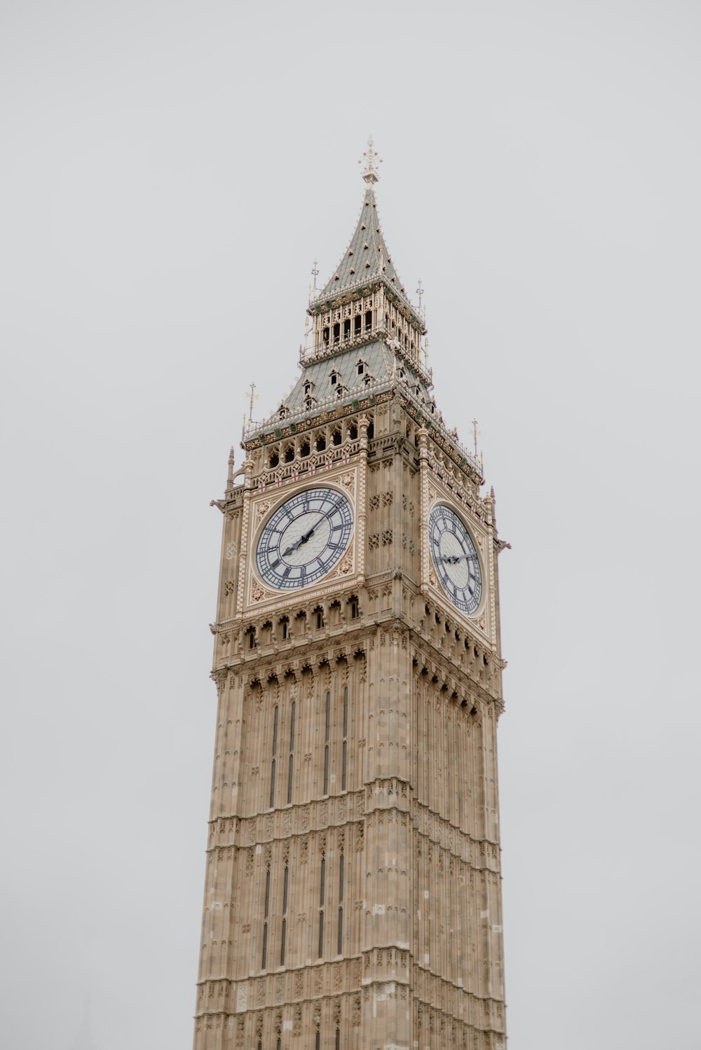 a tall clock tower with a clock on each of it's sides