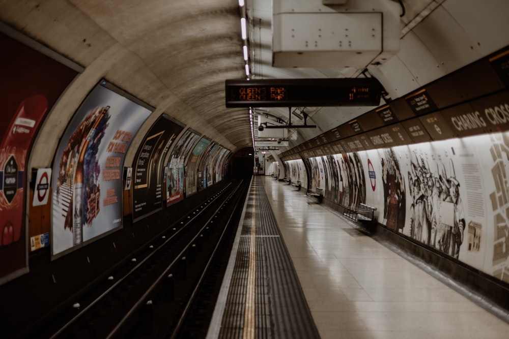 a subway station with a sign on the wall