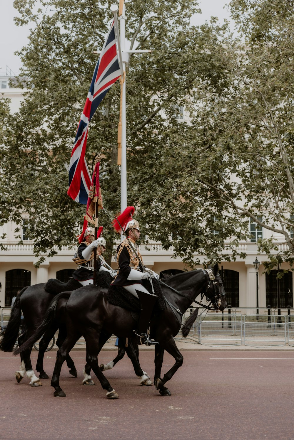 a group of men riding on the backs of black horses