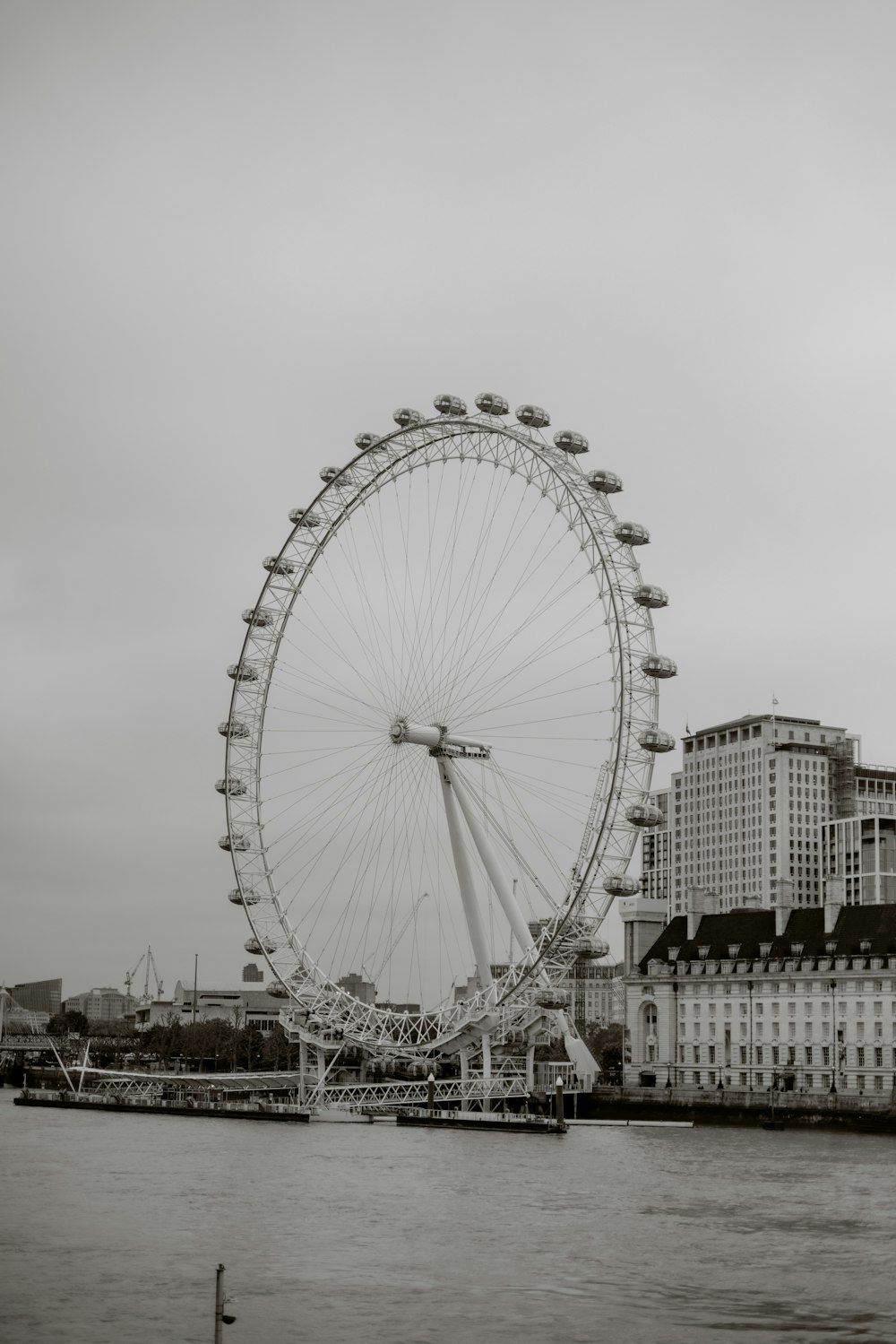 a large ferris wheel sitting in the middle of a river