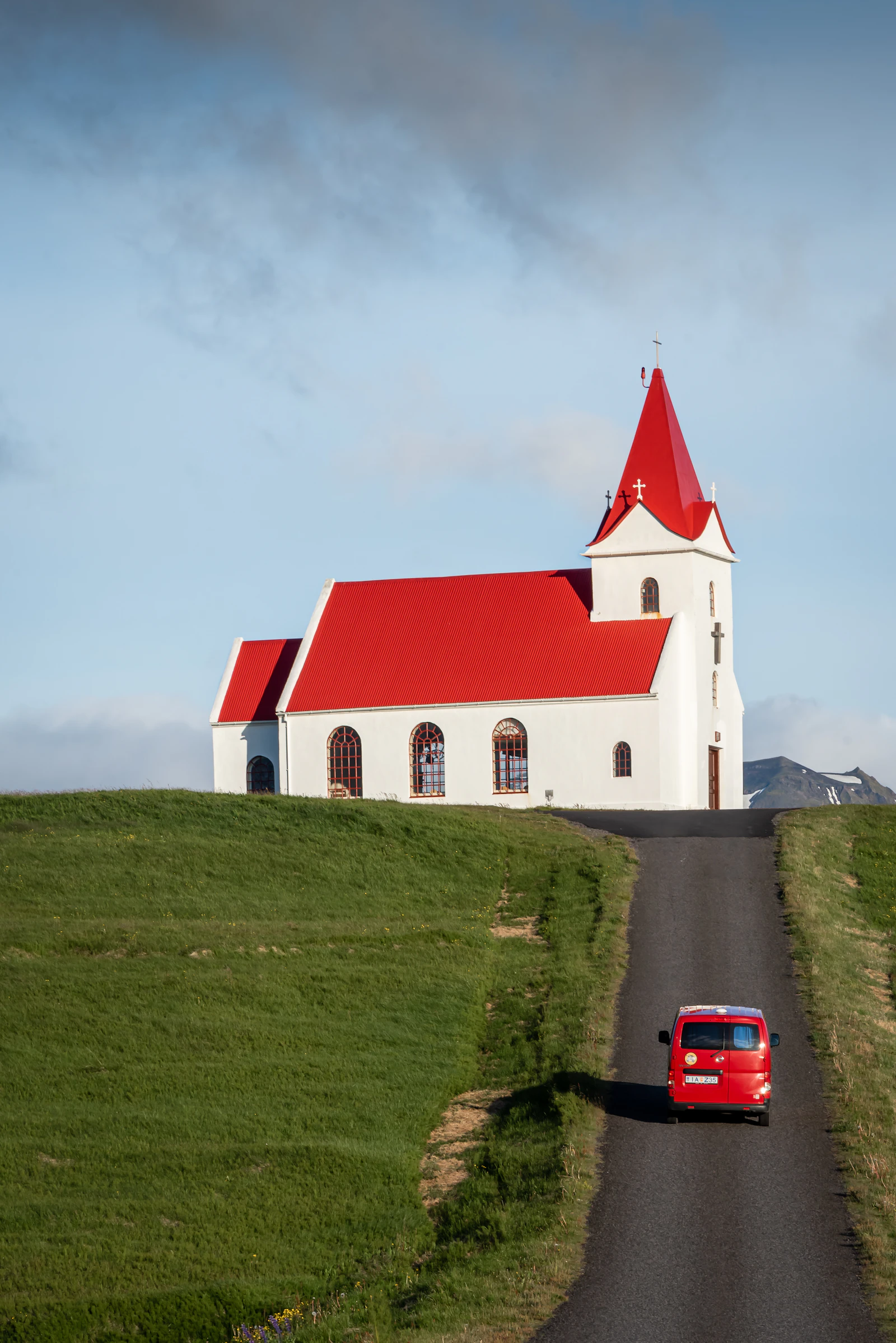 A rental-sized car beside an Icelandic country road