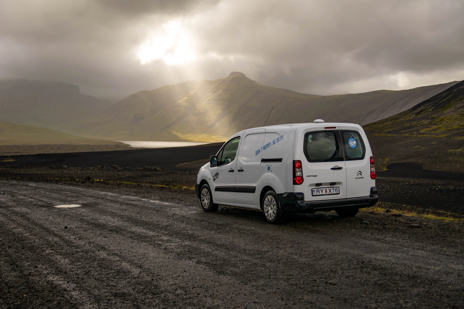 A campervan parked on a gravel road in Iceland