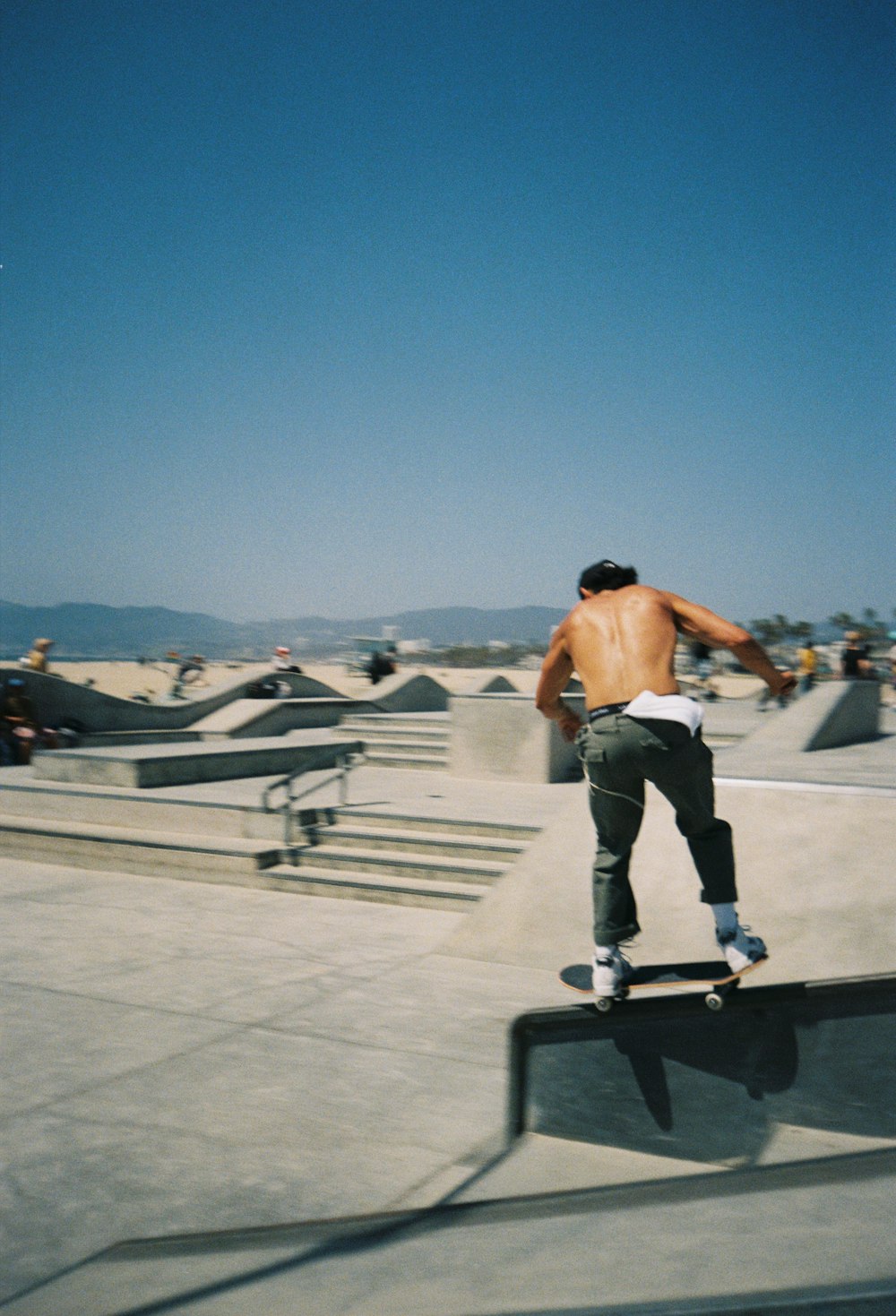 a man riding a skateboard down the side of a ramp