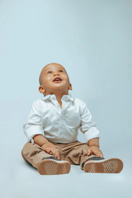 A quiet moment of gratitude as a young girl looks down at her new shoes, eyes shining.