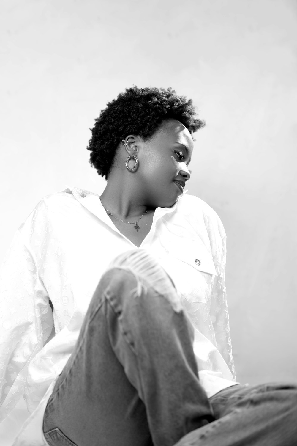 a black and white photo of a woman sitting down