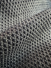 Close-up of black and white clothing details showcasing fabric texture and design.