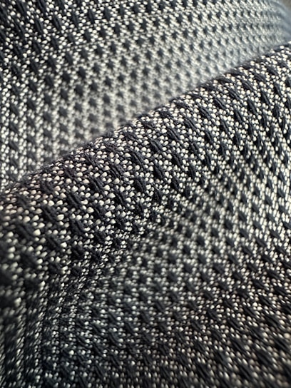 Close-up of a sleek black and white fabric texture, highlighting the fine weave of monochic's signature material.