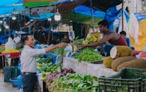 Farmers from mc farmer handing fresh produce to local market vendors in Kouilou.
