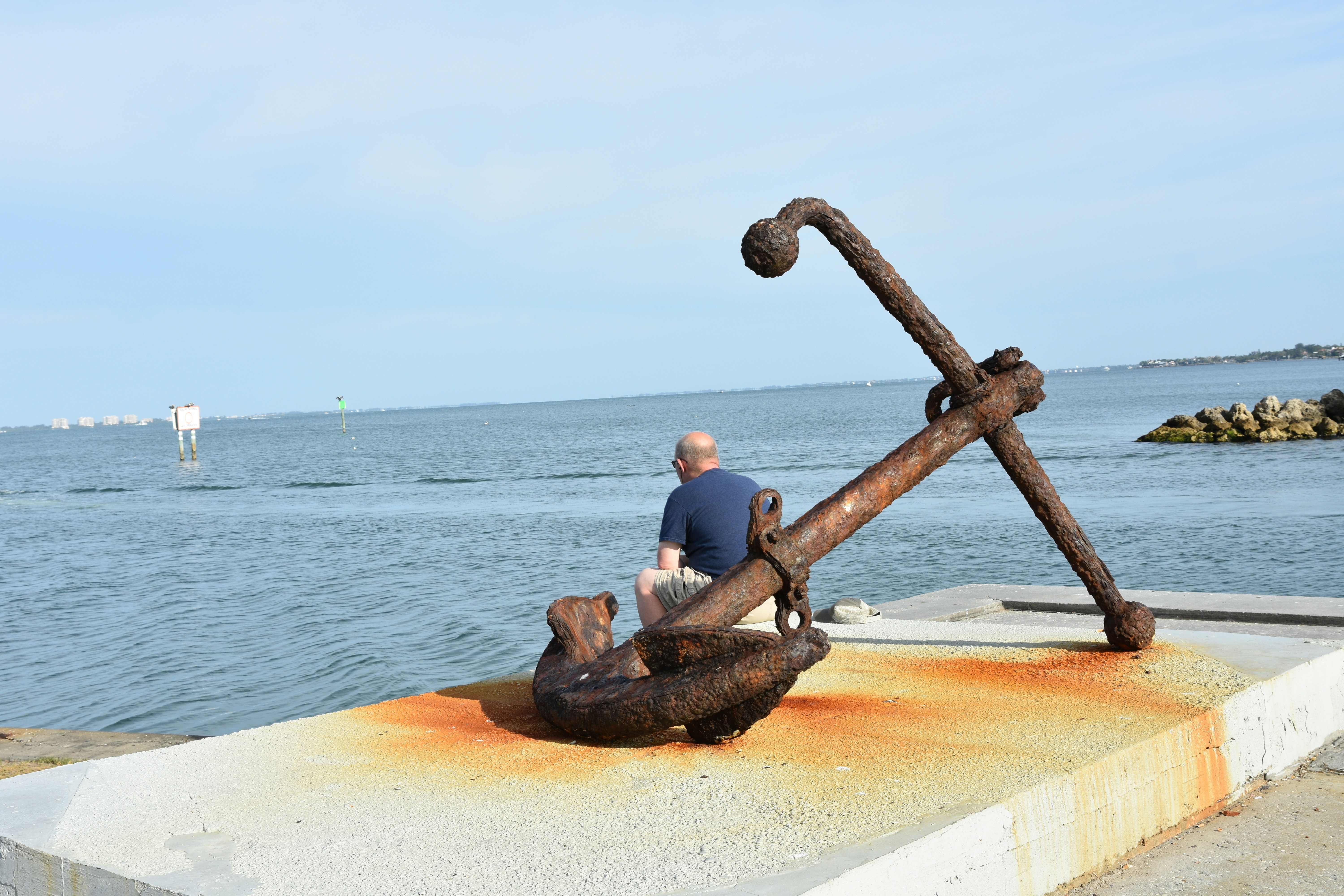 large concrete deadweight anchor being prepared on shore - boat dock anchor system