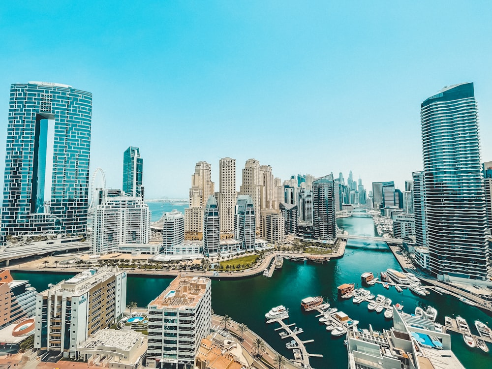 an aerial view of a city with boats in the water