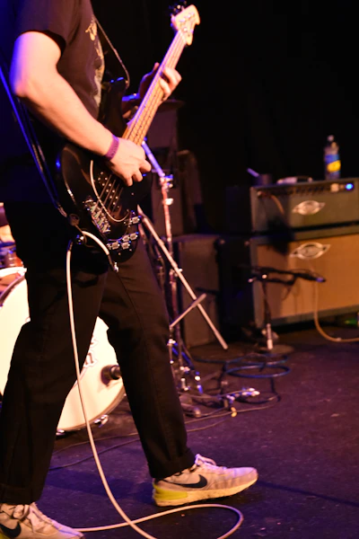 a man standing on a stage with a guitar