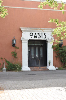 A vibrant storefront of Oasisfullservice in Ossining with colorful displays inside.