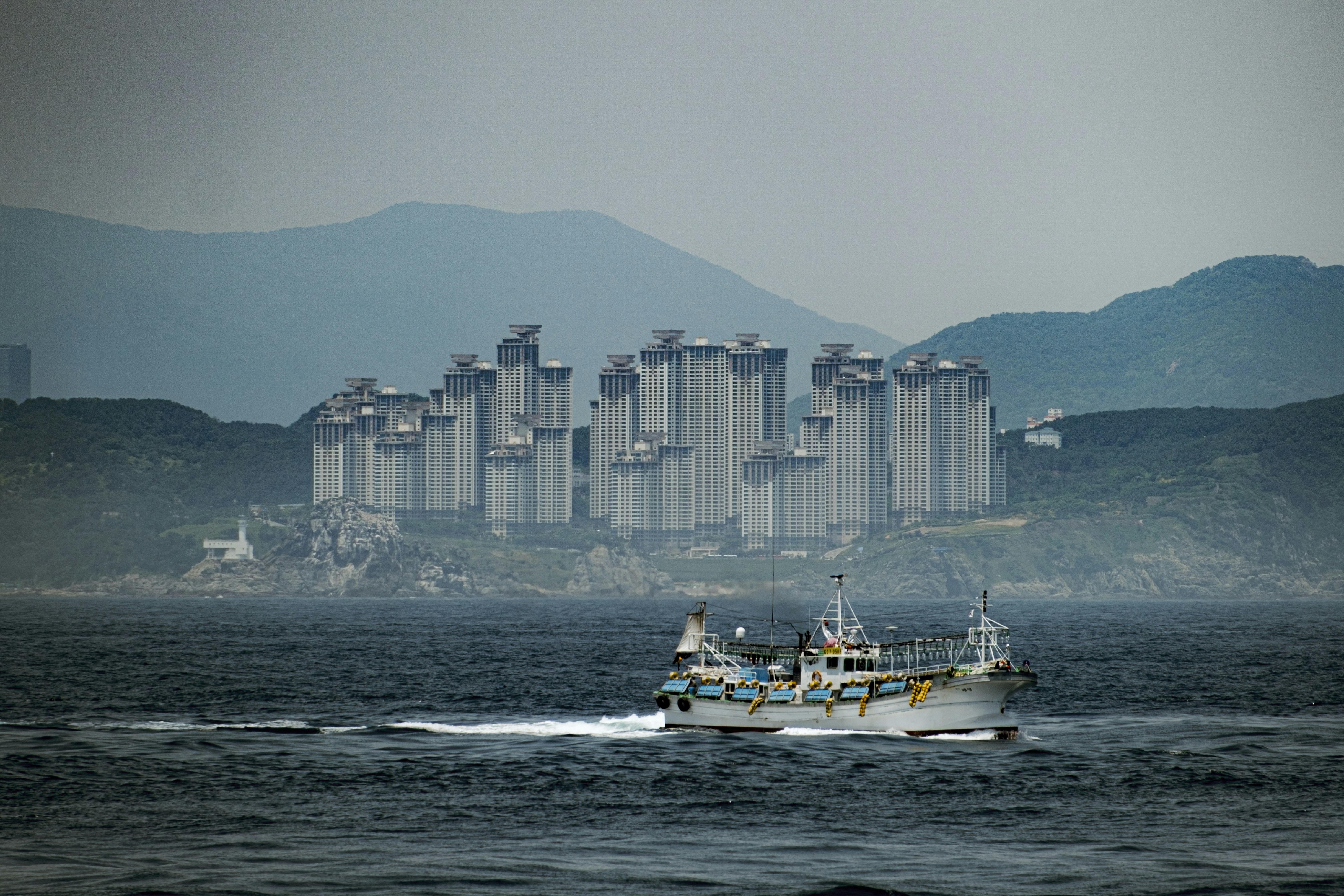 a boat in the water with a city in the background