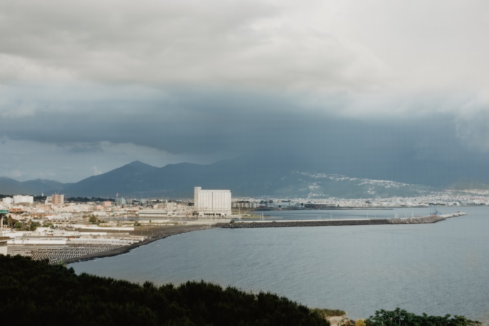 a large body of water with a city in the background