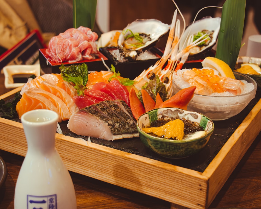 a wooden tray topped with lots of different types of food