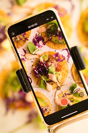 A user scanning a colorful meal with a smartphone, showing nutritional info overlay on the screen.