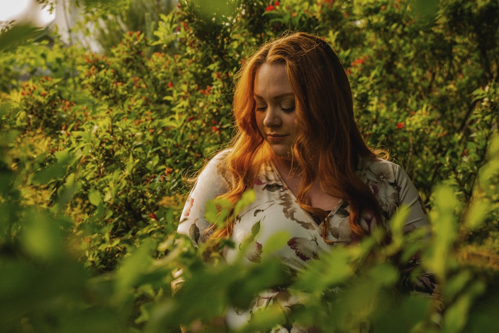 a woman standing in a field of flowers