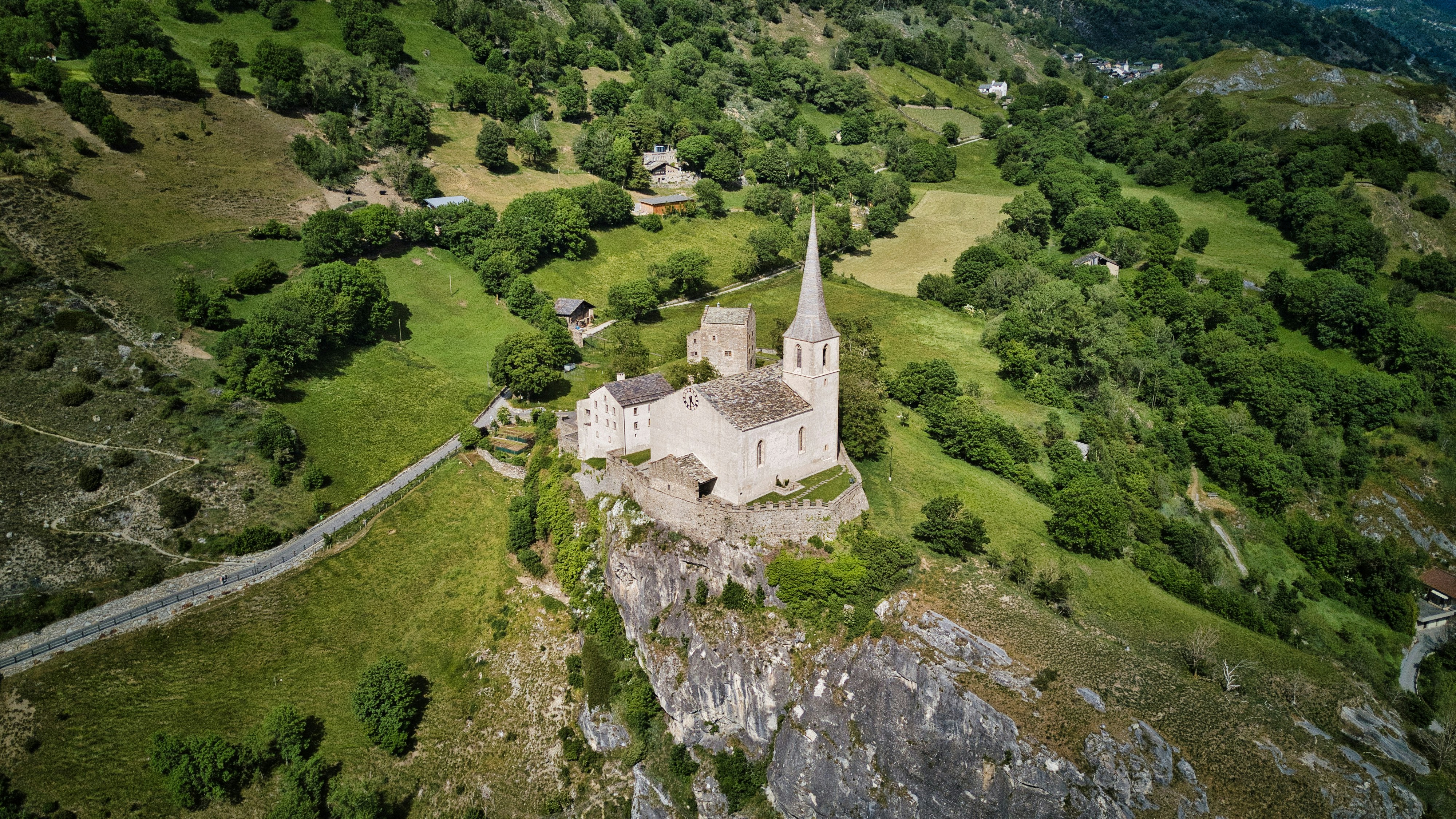 an aerial view of an old church in the mountains