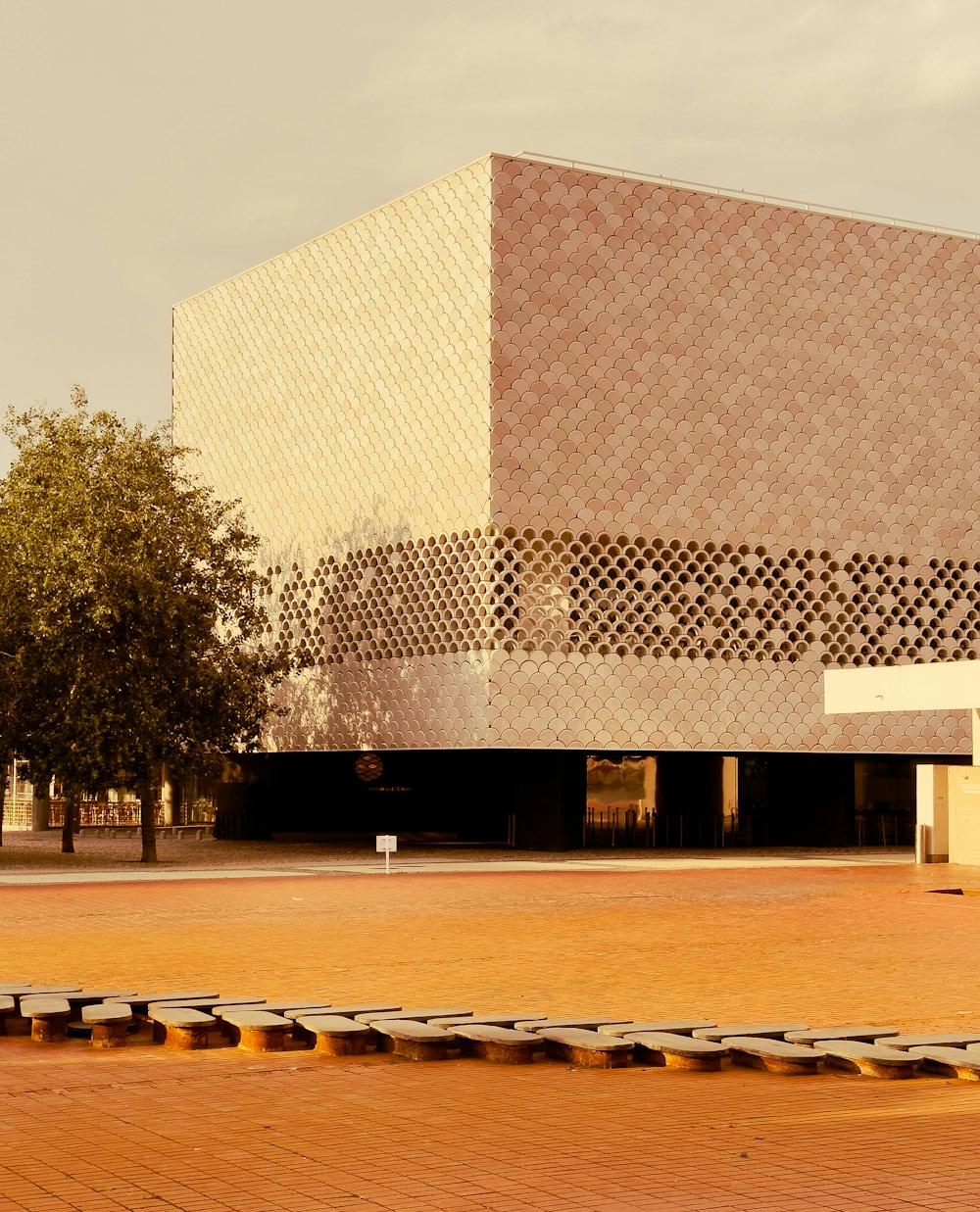 a large building with a tree in front of it