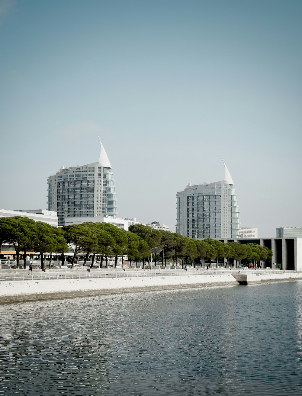 a body of water with buildings in the background