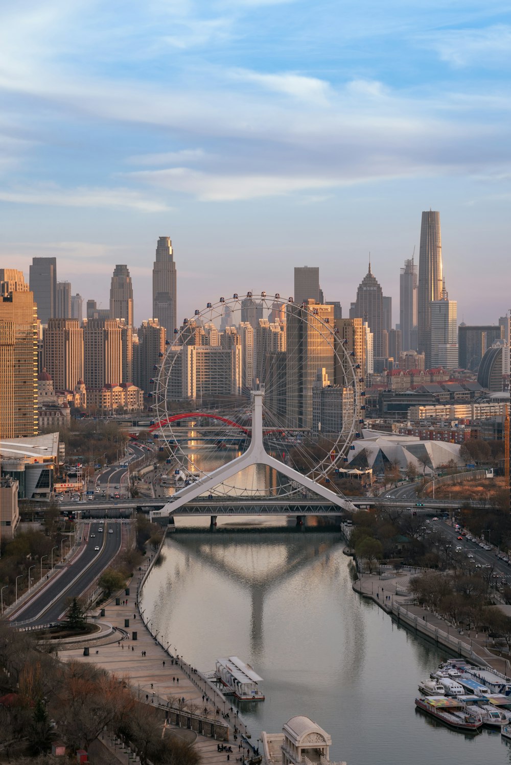 a city skyline with a ferris wheel in the foreground