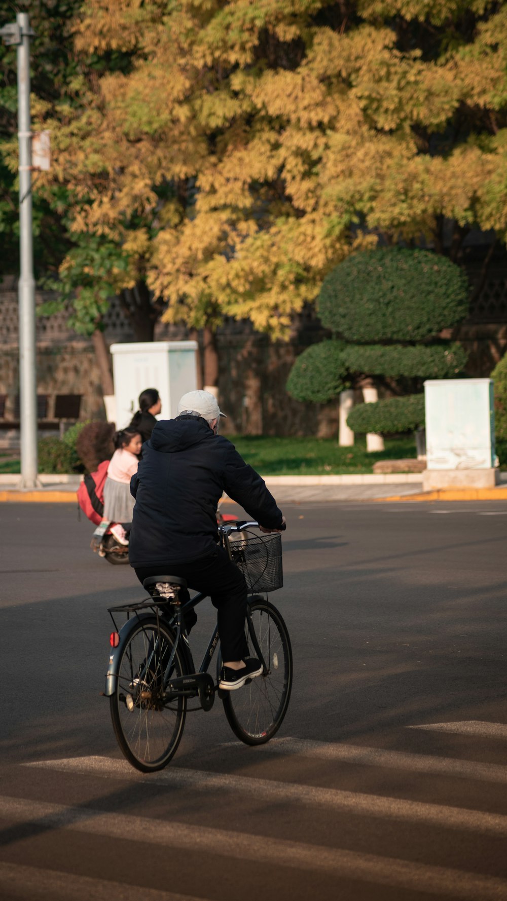 a man riding a bike down a street