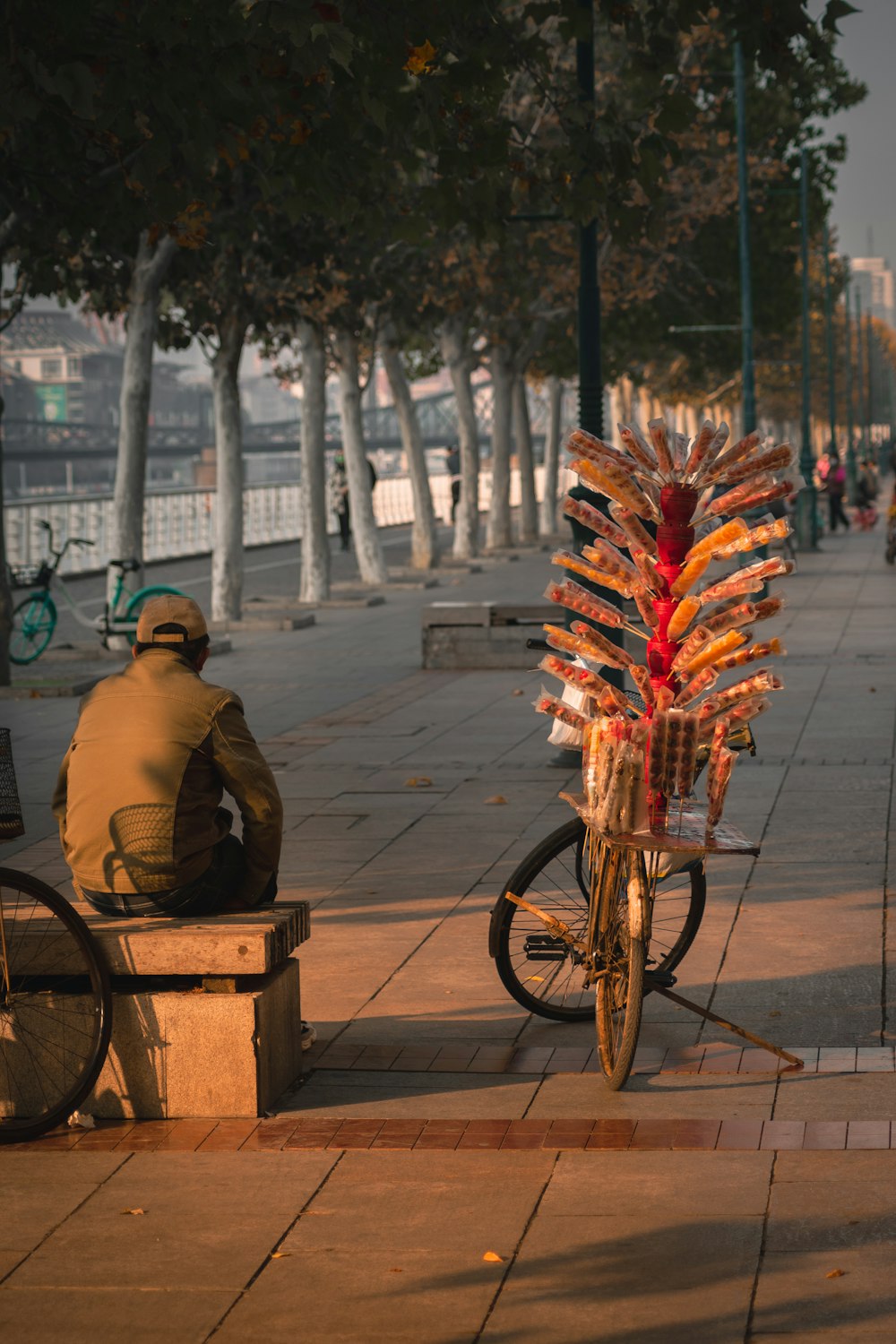 a man sitting on a bench next to a bike