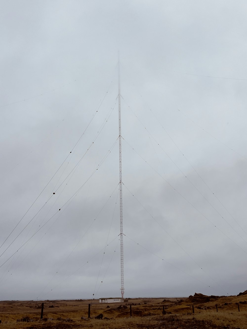 a very tall antenna on a cloudy day