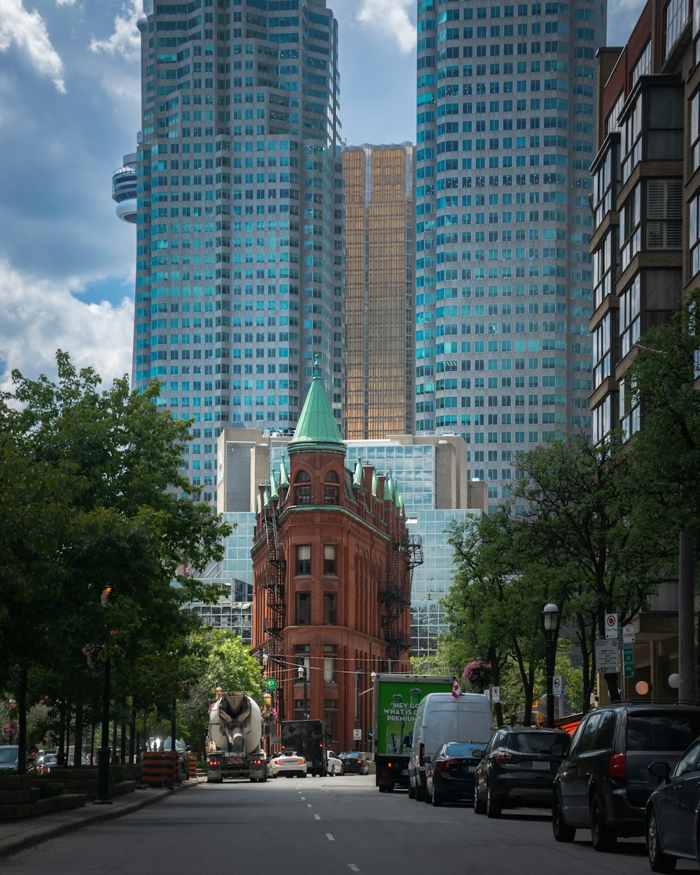 a city street with tall buildings in the background