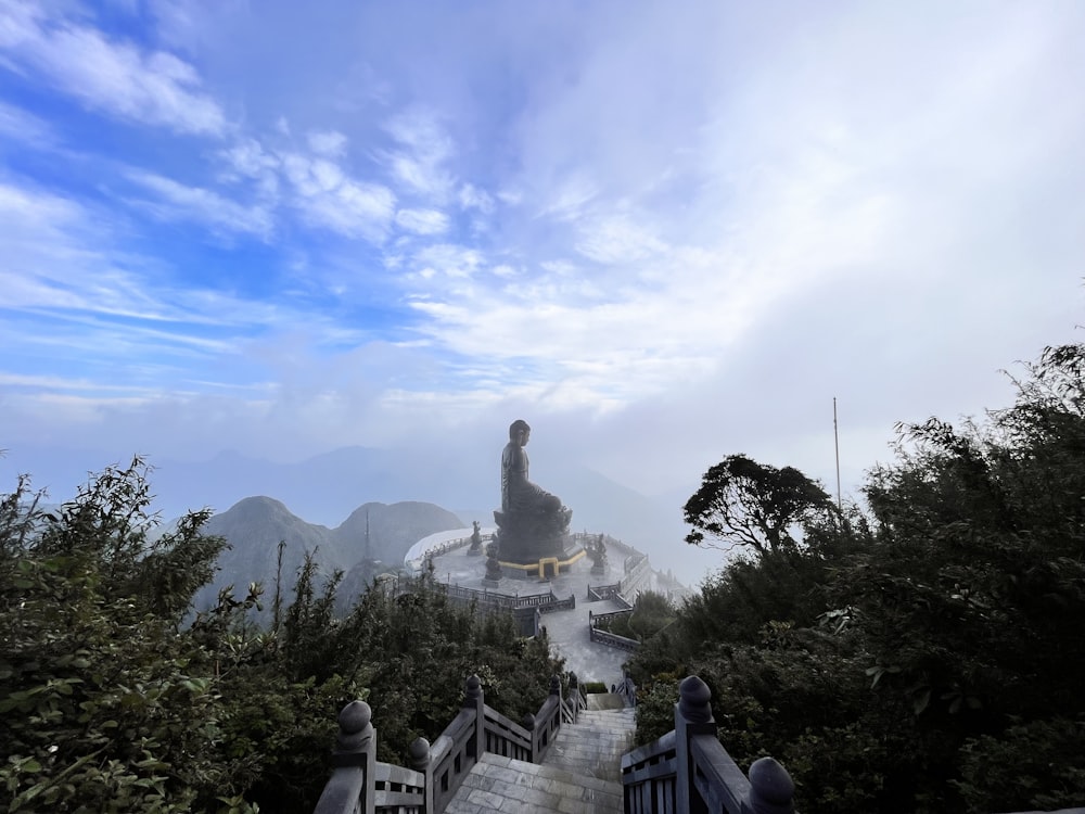 a large statue sitting on top of a hill