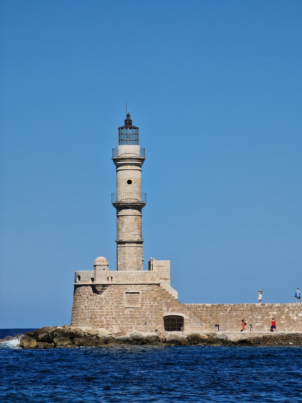 a light house sitting on top of a small island