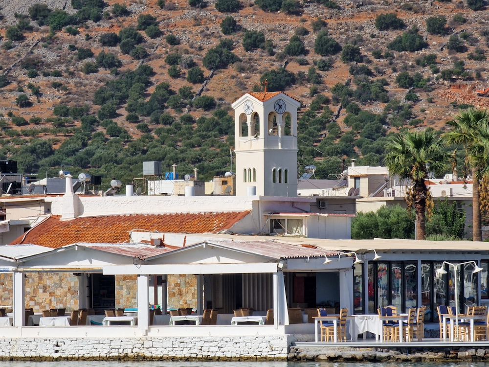 a building with a clock tower next to a body of water