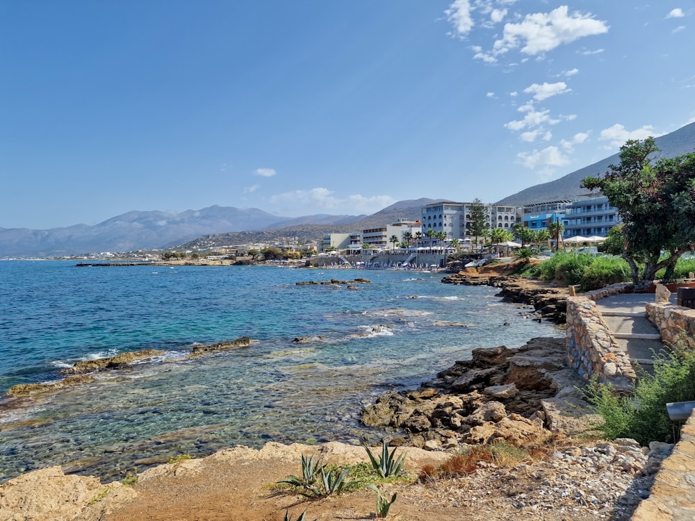 a view of a beach with a few buildings in the background